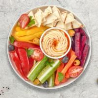 Homemade Hummus Salad · House made fresh hummus on a bed of vegetables.