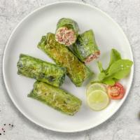 Grape Leaves  · (12 pieces) Grape leaves are stuffed with meat, herbs and rice mixture.
