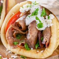 Lamb Gyro On Pita · Juicy lamb gyro meat slices with your choice of toppings on a fresh baked pita bread.