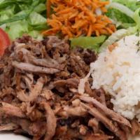 Lamb Gyro Over Rice · Juicy lamb gyro meat slices on a bed of rice.