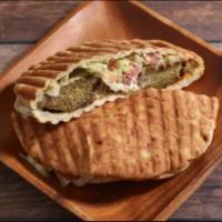 Classic Falafel Sandwich · Crispy falafels, salad, house-made white sauce, and hot sauce served in warm pita bread.