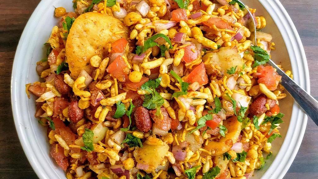 Bhel Puri · Puffed rice, potatoes, onions, tomatoes, mint and tamarind sauce.