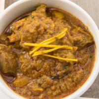 Goat Curry · Tender goat meat with bone cooked with mild spices at slow heat.