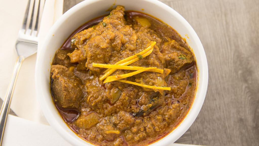 Goat Curry · Goat meat with bone cooked in authentic nepali style.
