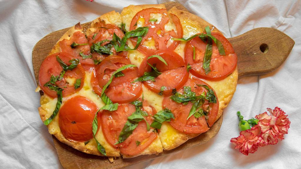 Herb Tomato · Fresh tomatoes w/ herbs, raclette cheese topped w/ balsamic fig glaze