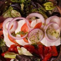 Caprese Salad · Fresh farm tomatoes, fresh mozzarella, red onions, roasted red peppers, and basil vinaigrette.