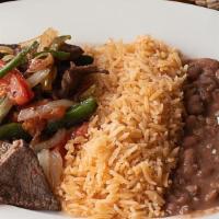 Bistec A La Mexicana · Beef steak sauteed with tomato, onions, and jalapeños served with rice, beans, salad, and co...