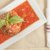 Stuffed Meat Ball · 100% beef, breadcrumb, Romano cheese, stuffed with ricotta and mozzarella and baked with tom...