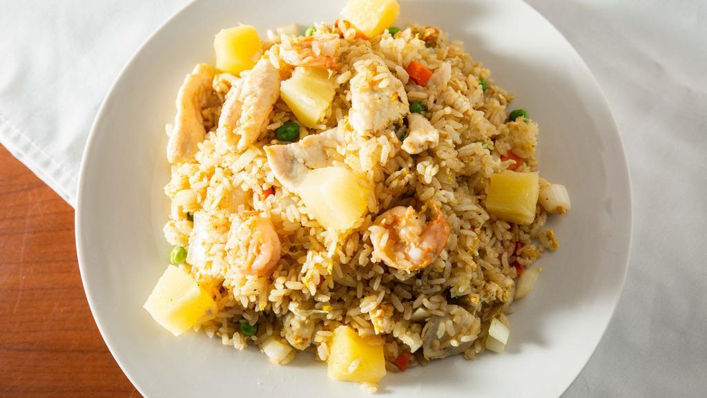 Pineapple Fried Rice · Fried rice with shrimp, chicken, eggs, onions, carrots, pea and pineapple with curry powder.