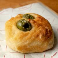 Focaccina Olive · Little round olive oil focaccia bread with olives on top.