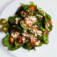 Spinach Mix Salad · Fresh feta cheese, almonds, tomatoes, raspberry vinaigrette in a bed of baby spinach.