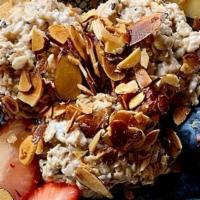 Blueberry & Coconut Bircher Muesli · Overnight coconut milk soaked oats, blueberries and agave topped with seasonal fruit and toa...