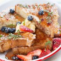 French Toast · with raspberry orange syrup, maple butter, fresh mint, & berries