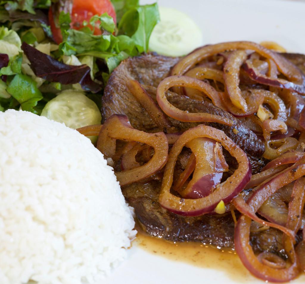 Bistec Encebollado · Steak with onions, rice and beans, salad and fried plantains or sweet plantains.