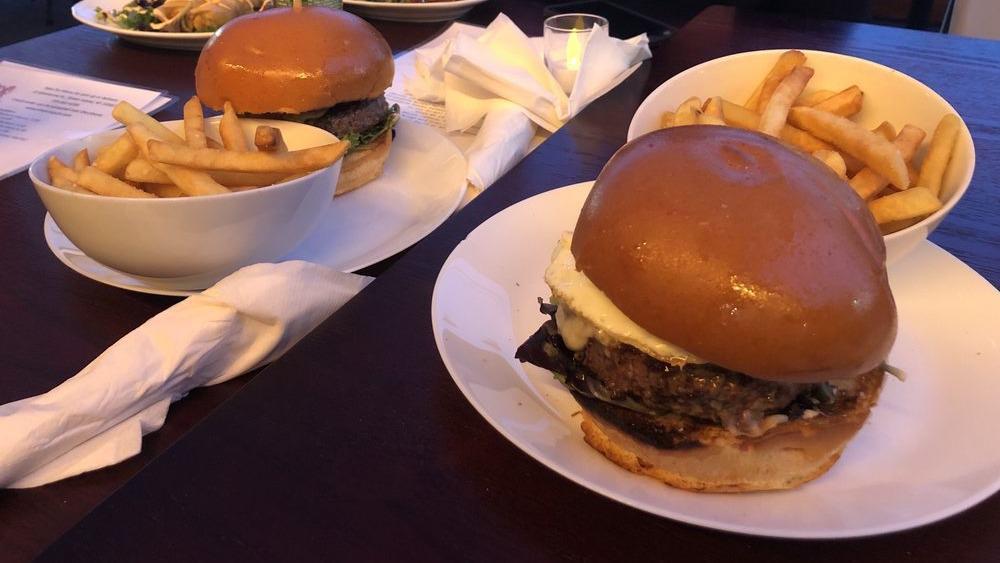 Pub Burger Served On A Brioche Bun With Fries · 