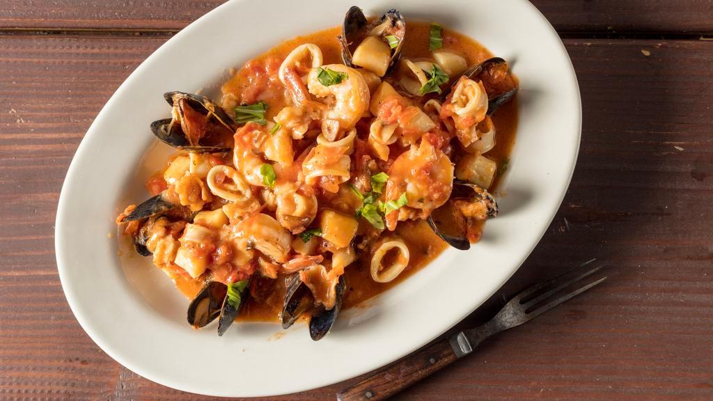 Seafood Stew · Fillet of sole, shrimp, calamari, mussels, garlic, plum tomatoes, an white wine sauce.