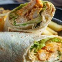 Spicy Buffalo Chick'N Wrap · Sandwich with crispy, plant-based chicken with lettuce, tomato, pickles, and onions. Served ...