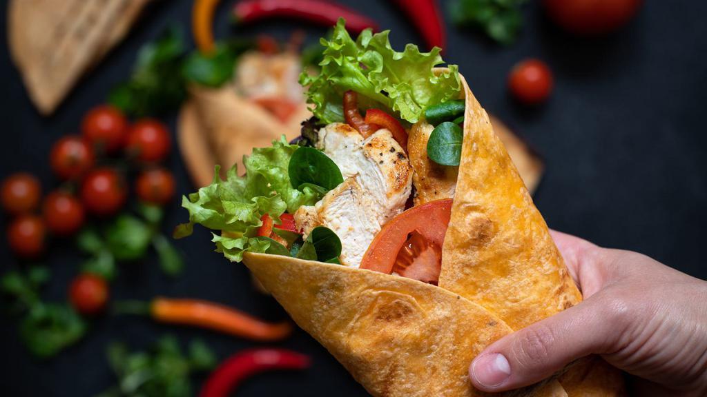 The Crunch Wrap · Corn tortilla filled with seasoned Beyond meat, melted vegan cheese, pico de gallo, avocado, lettuce, tomatoes, and vegan sour cream. Served with fries.