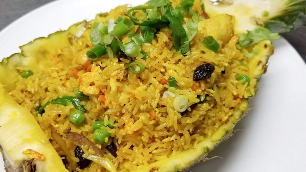 Thai Pineapple Fried Rice · Fresh made jasmine rice stir fried with egg, pineapple, raisin, cashew nut and fresh vegetable. Add chicken, beef, pork or shrimp for an additional charge.