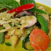 Green Curry · Medium spicy. Coconut milk with green curry, snow peas, eggplants, bamboo shoots, carrots, g...
