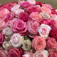 Bed Of Roses · A massive cluster of roses  covering a 12” wide round vase, forming the perfect center piece.