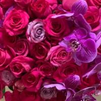 Exotic Darkness  · Massive mix of hot pink and purple roses, and purple orchids arranged in a glass vase