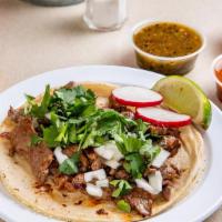 Steak Taco (Order Of 3) · Grilled steak. Tacos topped with fresh onions and cilantro, garnish with a lime wedge and, r...