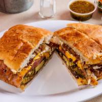 Al Pastor Torta · Grilled pork, onions, pineapple and melted cheese. Traditional Mexican sandwich, served on a...
