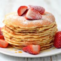 Fluffy Strawberry Pancakes · Fluffy buttermilk pancakes covered with strawberries served with butter and syrup.