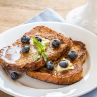 Blueberry French Toast · Original blueberry fluffy triangle shaped French toast slices served with butter and syrup.