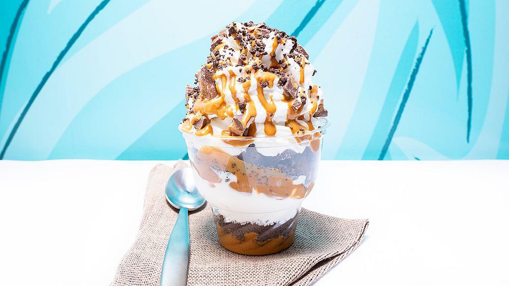 Peanut Butter Crunch · Vanilla ice cream with peanut butter sauce, peanut butter cups and chocolate crunch. Topped with homemade whipped cream, drizzled with peanut butter sauce and broken peanut butter cups.