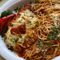Spaghetti Chicken Parm · Chicken parmigiana with spaghetti and homemade tomato sauce topped with parmesan cheese.