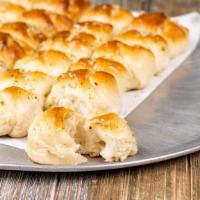 Garlic Knots · A classic snack, our garlic knots are strips of pizza dough tied in a knot, baked and then t...