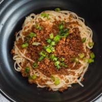 Crispy Dan Dan · Spicy. Crispy minced pork, dry sprouts, garlic, scallion, and hot oil.