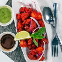 Chicken 65 · Boneless cubes of chicken marinated in corn with our batter with spices, deep fried and toss...