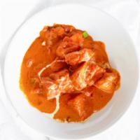 Butter Chicken · Succulent pieces of chicken cooked in rich tomato sauce with herbs, spices and touch of butt...