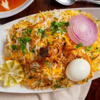 Chicken Biryani · Basmati rice cooked with chicken blendedwith herbs and spices, then garnished with egg, onio...