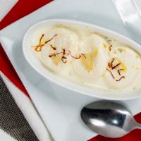 Rasmalai · Indian cheese dumplings served in sweetened flavored milk garnished with pistachio and almon...
