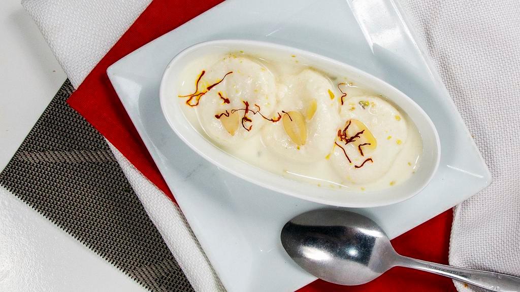 Rasmalai · Indian cheese dumplings served in sweetened flavored milk garnished with pistachio and almonds.