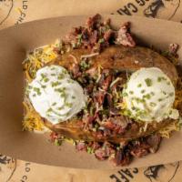 Loaded Baked Potato · Giant baked potato topped with butter, shredded cheddar jack, sour cream, and chives.
560-93...
