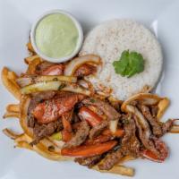 Lomo Saltado · Strips of steak sauteed with onions, tomatoes, served over fries with white rice
