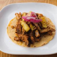 Al Pastor · Grilled marinated pork steak served with grilled pineapple, red onion, and chili lime crema.