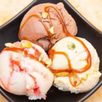 Ice Cream · Three scoops of ice cream served with chocolate sauce.