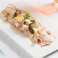 Vitello Tonnato · Slow cooked and thinly sliced veal with tuna sauce.