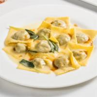 Agnolotti Di Brasato · Homemade ravioli filled with braised meats topped with sage butter and veal reduction.