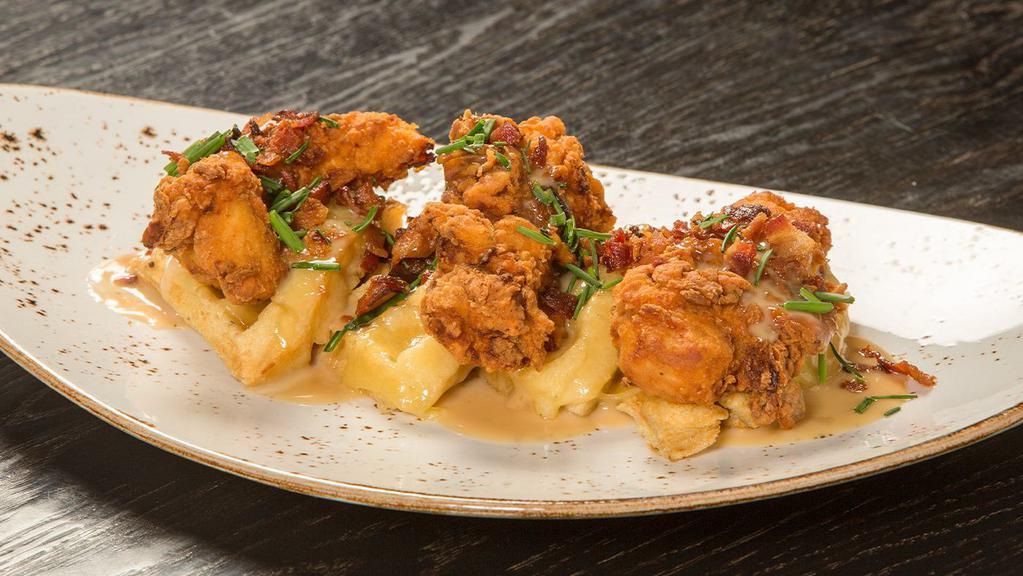 Chicken & Waffles · Buttermilk fried chicken, gruyère, applewood bacon, maple syrup reduction.