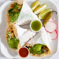 Taco Pollo · Grilled chicken, guacamole, onion, and cilantro.