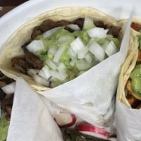 Taco Mixto · Chicken and beef, guacamole, onion, and cilantro.