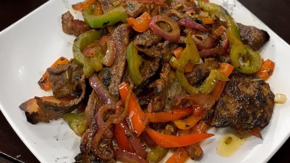 Fajita De Res · Beef sautéed with peppers, onions, and served with white rice and black beans.