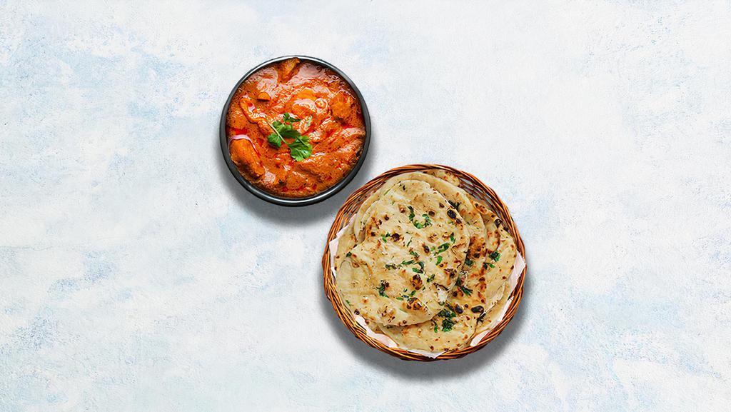 Chicken Tikka Masala & Garlic Naan · Oven-roasted chicken chunks in a rich creamy tomato and onion based gravy. Served with Indian flatbread baked to perfection in a traditional Indian clay oven and sprinkled with minced garlic and herbs.